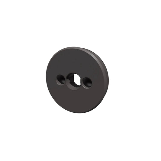 Black circular object with two holes on a light gray background